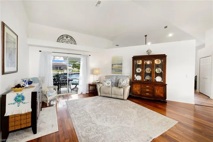 Living room featuring dark wood-type flooring and recessed lighting