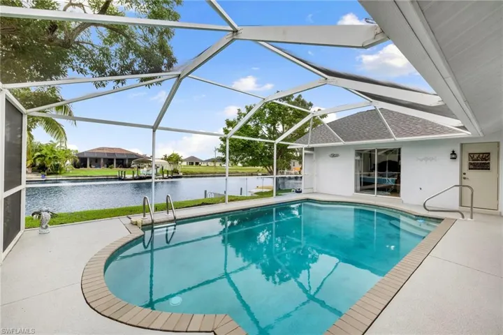 Outdoor pool featuring a patio area, a sunroom, a lanai, and a water view