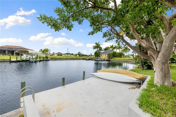 Dock with a water view and a residential view