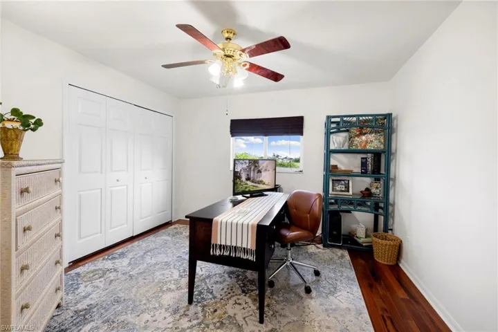Office space with wood finished floors and ceiling fan