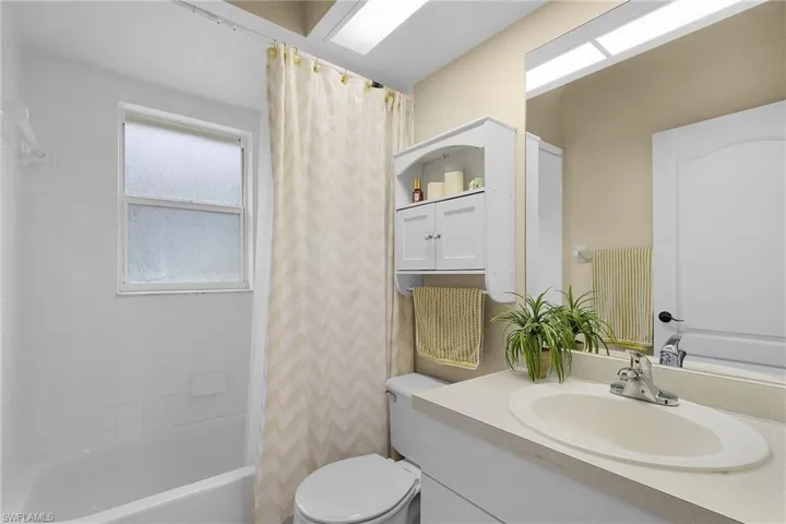 Full bathroom with shower / bath combo and vanity