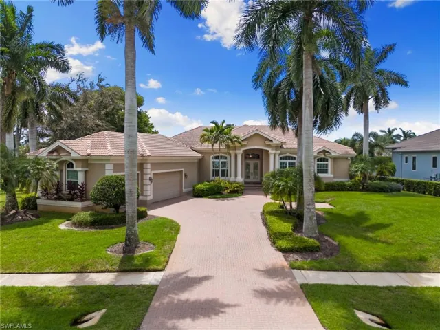 View of front of home featuring a front yard and a garage