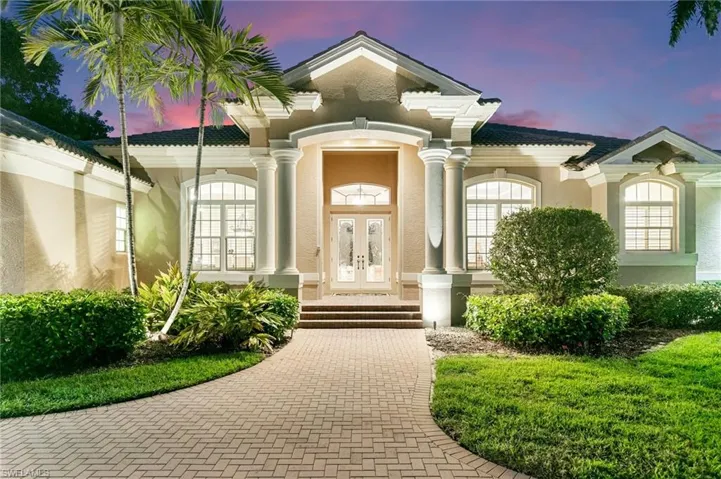 Exterior entry at dusk featuring french doors