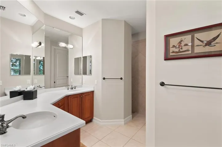 Bathroom featuring a shower, tile patterned flooring, and vanity