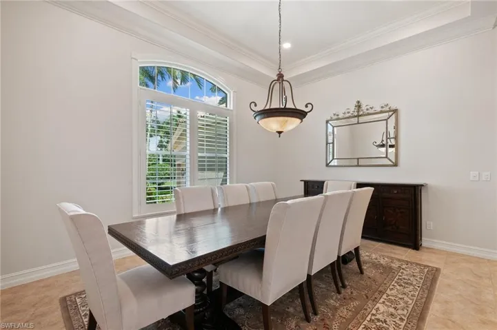 Tiled dining area with crown molding