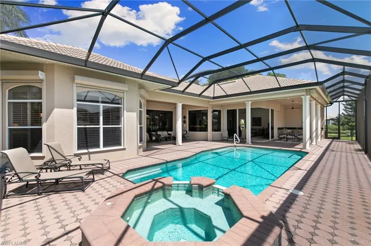 View of pool with a lanai, an in ground hot tub, and a patio area