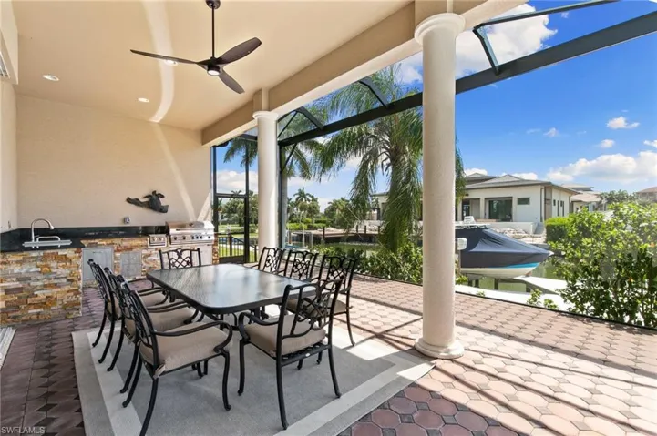 View of patio / terrace featuring sink, ceiling fan, and exterior kitchen