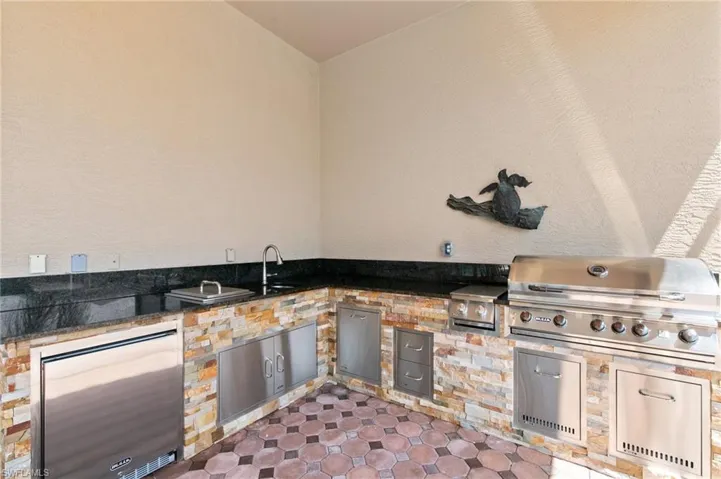 View of patio / terrace with area for grilling, sink, and an outdoor kitchen