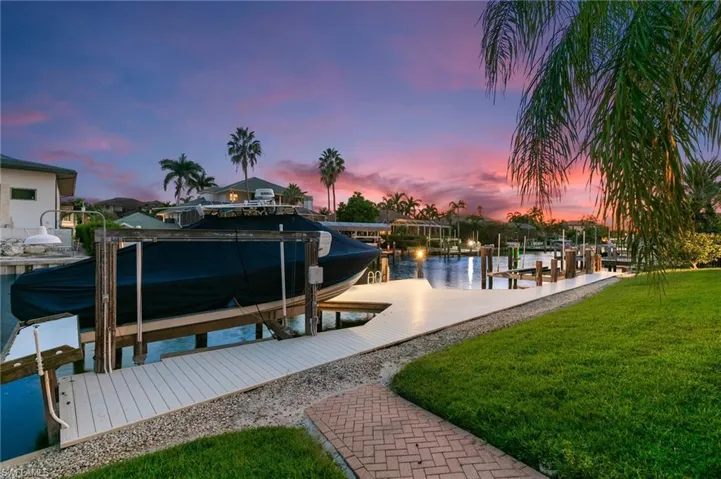 Dock area featuring a lawn and a water view