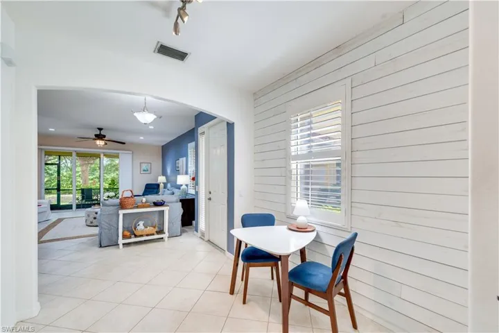Breakfast area with light tile patterned flooring, and shiplap walls