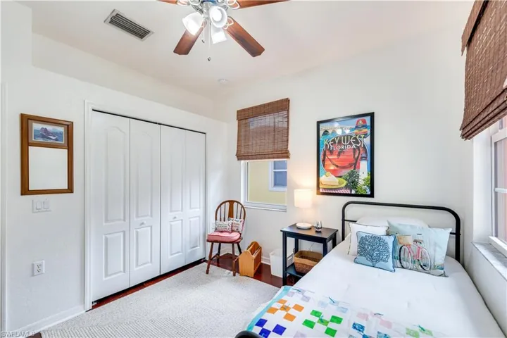 Bedroom with ceiling fan and a closet