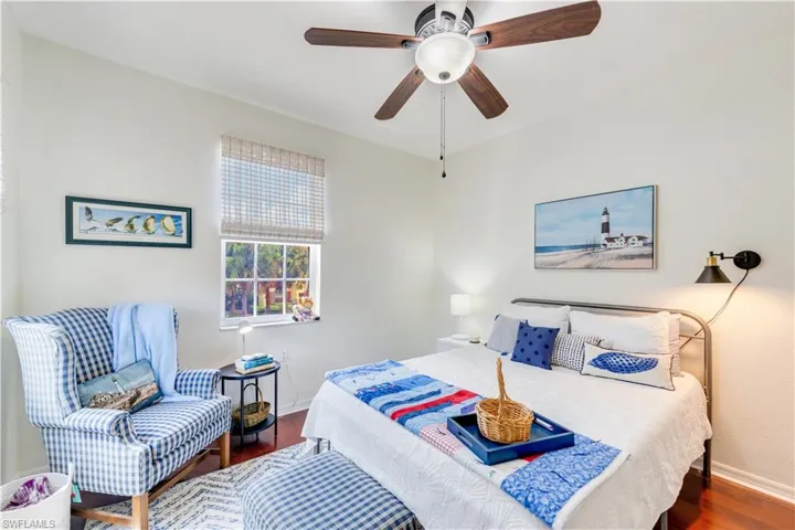 Bedroom featuring ceiling fan and dark hardwood / wood-style flooring