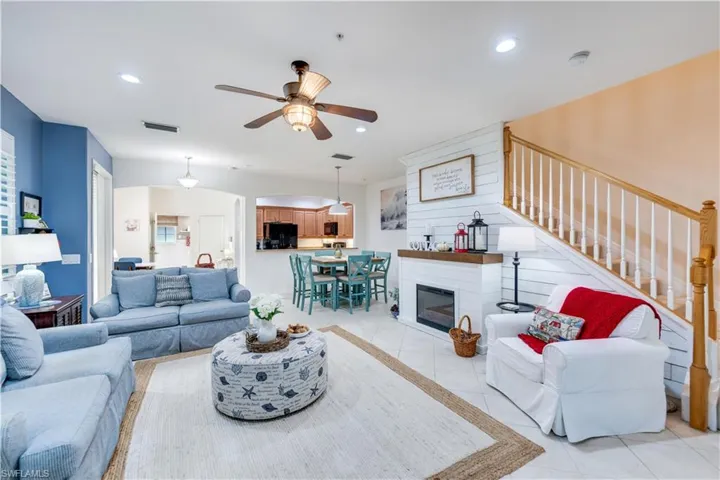 Living room featuring ceiling fan and light tile patterned floors