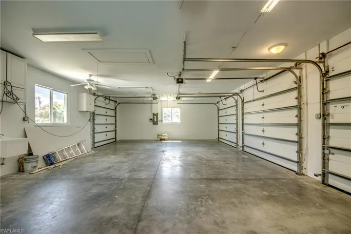Four garage doors featuring sink and ceiling fan