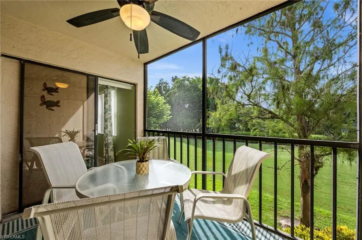Screened lanai framing a green view over the golf course, ready for morning coffee or an evening drink.