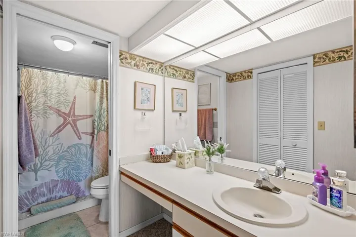 Bathroom vanity with an integrated sink and a large wall-mounted mirror