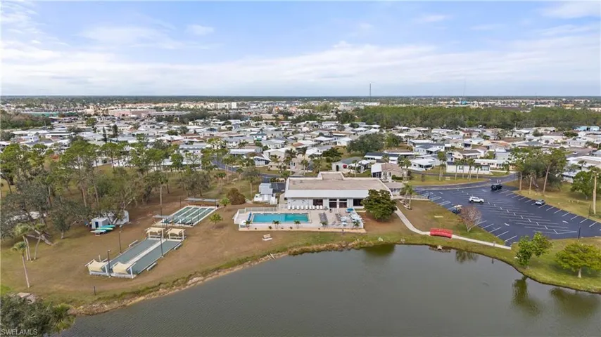 Aerial view of property and surrounding area featuring a large body of water and nearby suburban area