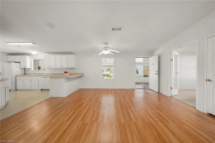 Unfurnished living room featuring light wood-style flooring and a ceiling fan