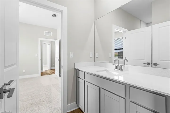 Spare room with light colored carpet and baseboards