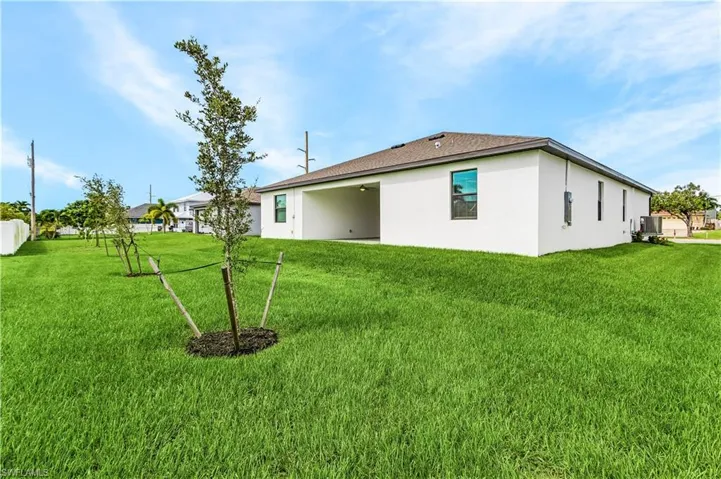View of exterior entry with ceiling fan, a patio area, and stucco siding
