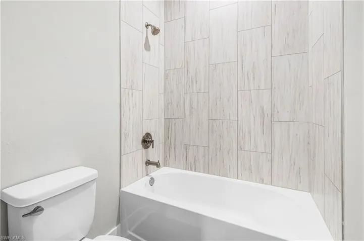 Unfurnished bedroom featuring dark wood finished floors and baseboards