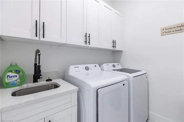 Laundry room featuring washer and dryer and cabinet space