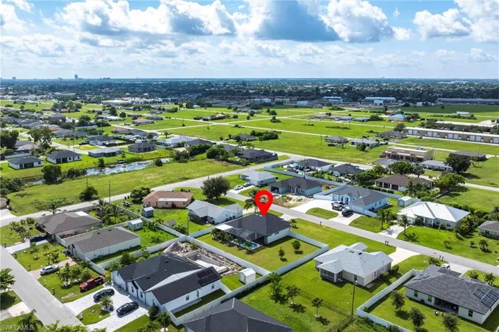 Aerial perspective of suburban area featuring a nearby body of water
