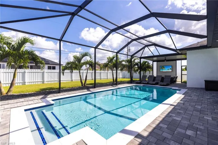 View of pool with a patio and a sunroom