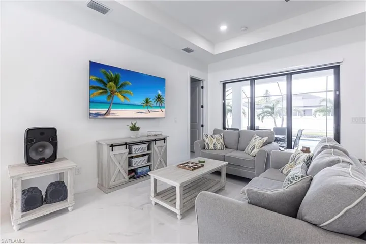 Living room with marble finish flooring and recessed lighting