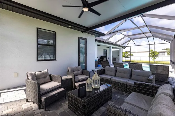 View of patio featuring ceiling fan, an outdoor hangout area, a sunroom, a lanai, and an outdoor pool