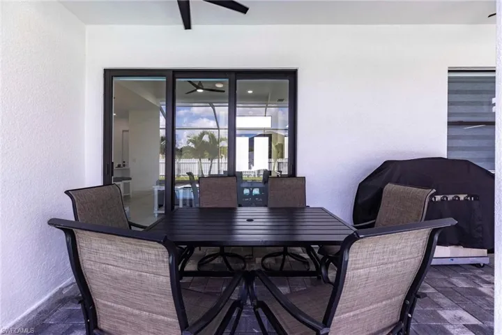 Dining space featuring a textured wall and ceiling fan