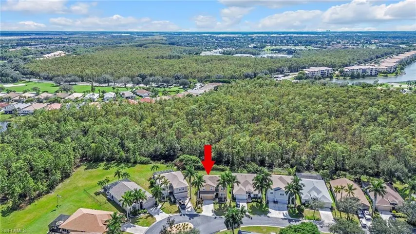 Aerial view of property's location with nearby suburban area and a nearby body of water