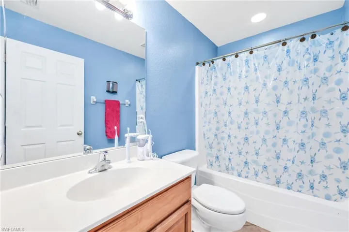 Full bath featuring vanity and shower / tub combo