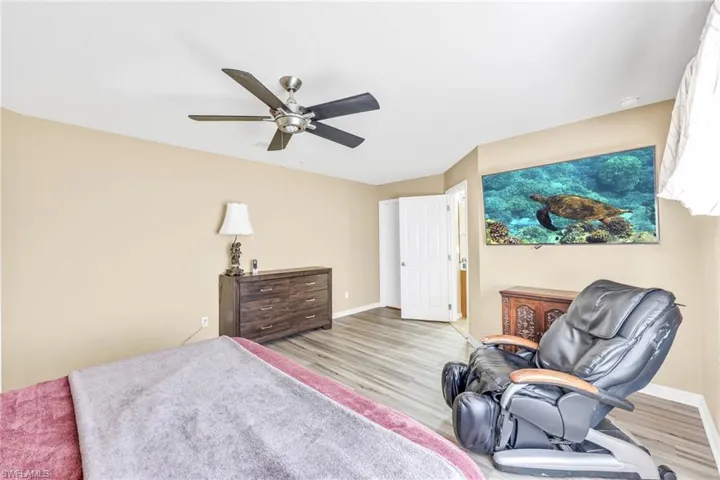 Bedroom featuring wood finished floors and a ceiling fan