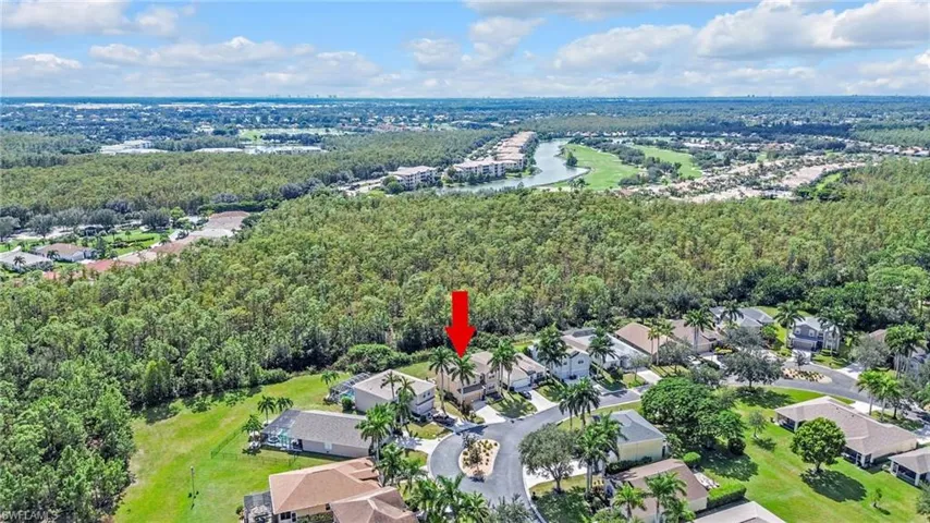 View of property location with nearby suburban area and a heavily wooded area