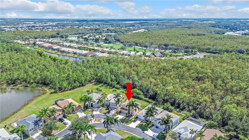Aerial view of property's location with nearby suburban area and a nearby body of water