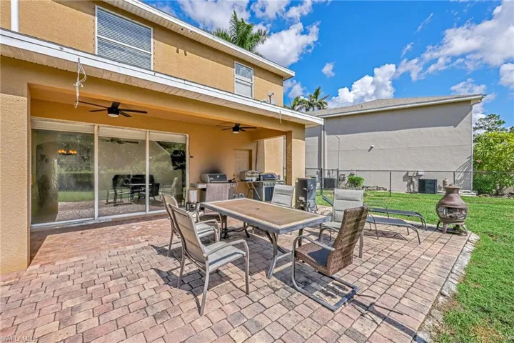 View of patio / terrace with outdoor dining space, ceiling fan, and area for grilling