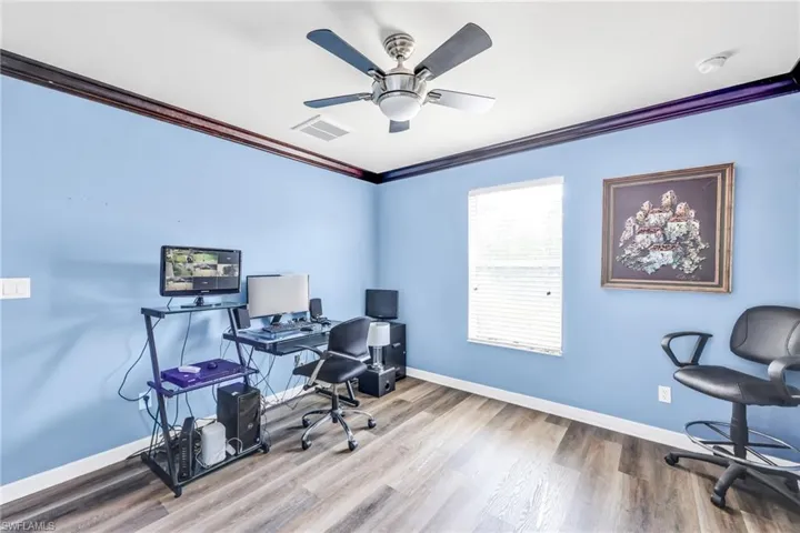 Bedroom/Office featuring crown molding, wood finished floors, and ceiling fan