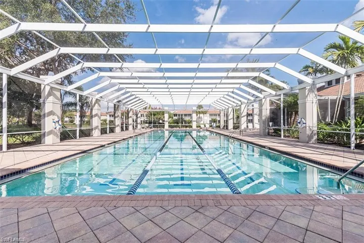 View of pool with a lanai and a patio