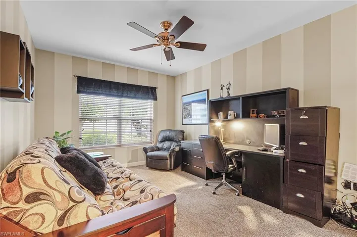 Carpeted office space with ceiling fan