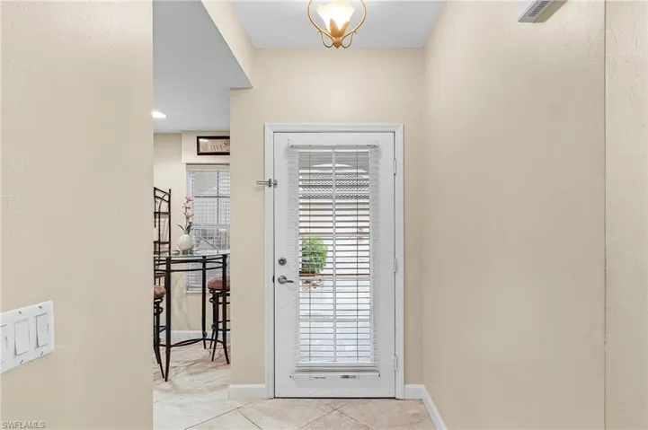 Doorway to outside with light tile patterned flooring