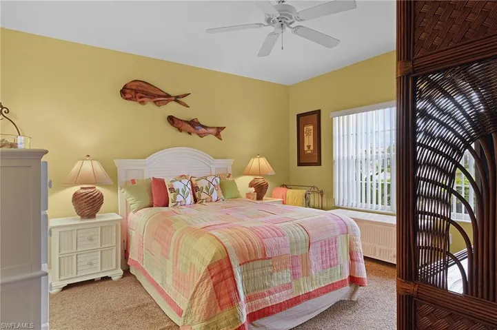 Carpeted bedroom with ceiling fan