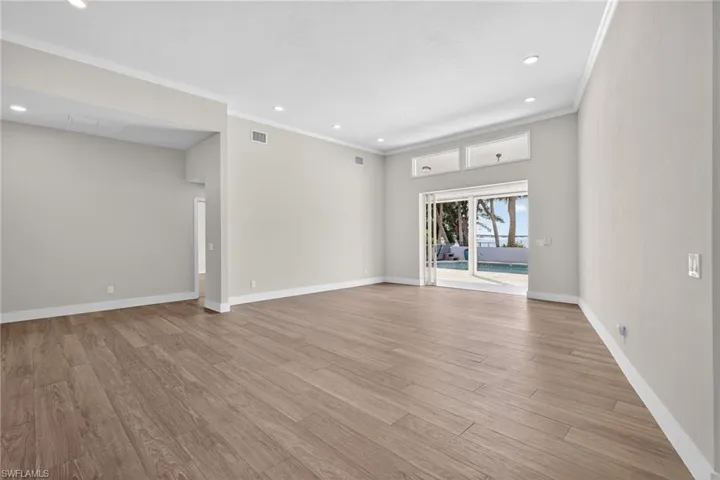 Spare room featuring light wood-style floors, recessed lighting, and crown molding