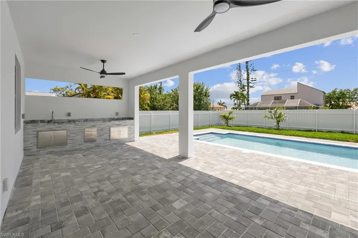 View of pool featuring ceiling fan