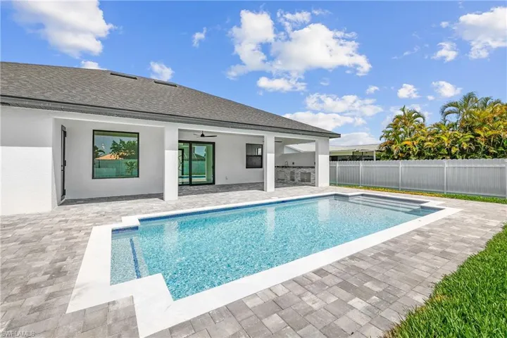 View of swimming pool with a patio and ceiling fan