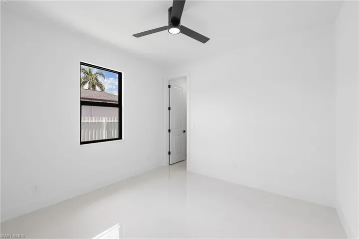 Empty room with tile floors and ceiling fan