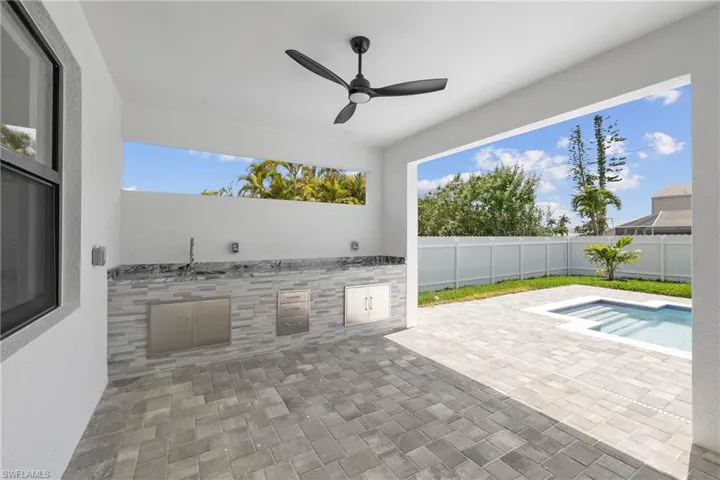 View of terrace featuring ceiling fan and a fenced in pool