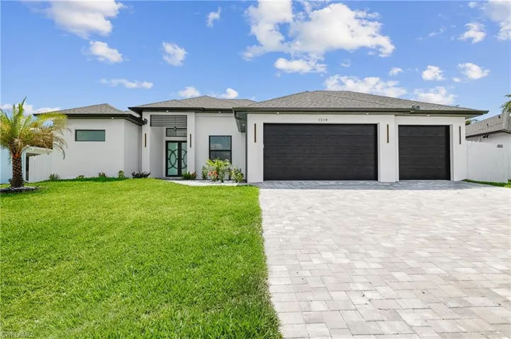 Prairie-style house featuring a garage and a front yard
