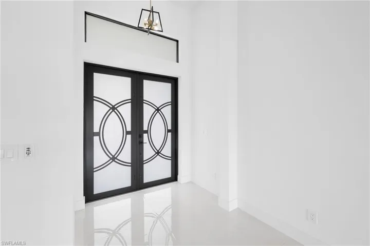 Entrance foyer featuring tile flooring and french doors