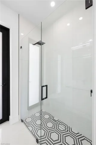 Bathroom featuring walk in shower and tile flooring